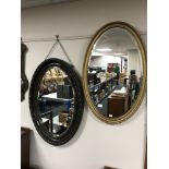 Two early 20th century oval framed mirrors