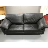 A contemporary black leather settee