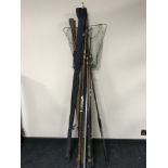 A collection of vintage fishing rods and a landing net