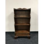 A set of mahogany open bookshelves fitted a drawer