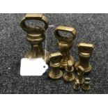 A graduated set of eight brass weights ranging from 2lbs to 1/4 oz