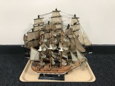 Three masted wooden model ships on stands