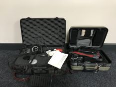 A cased Sony video camera and a cased Pentax A3 camera with lens and accessories