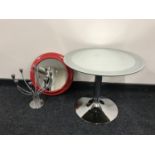 A circular mirrored top occasional table on chrome,