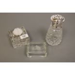 A cut glass inkwell with silver lid,