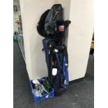 Two golf bags containing three hickory shaft drivers, three irons, golfing novelties, ball markers,