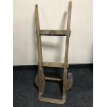 A vintage wooden hand truck bearing a Great Western Railway plaque