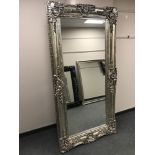 A very large silvered overmantel mirror in ornate frame,