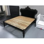 A pine 6' bed frame and a black Rococo style headboard in black button fabric
