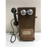 A vintage oak cased telephone box with bakelite hand set