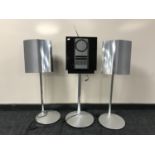 A Bang & Olufsen Beosound 3000 CD player on stand and a pair of speakers on stands