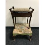 An Edwardian storage piano stool and music books and a tapestry footstool