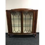A mahogany display cabinet on claw and ball feet