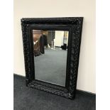 A Victorian style black framed mirror