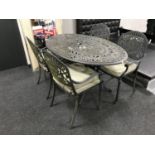 A cast metal oval patio table,