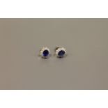 A pair of 18ct white gold sapphire and diamond cluster earrings CONDITION REPORT:
