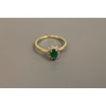 A 9ct gold emerald and diamond cluster ring,