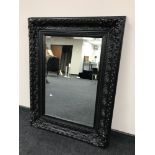 A Victorian style black framed mirror