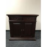 An Indonesian double door sideboard in a mahogany finish