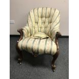 A Victorian armchair upholstered in stripe fabric