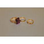 An 18ct gold ruby and diamond ring, a 9ct gold band ring and a gold ring set with a large amethyst,