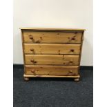 A pine four drawer chest