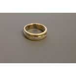 An 18ct gold diamond half eternity ring, size M/N.