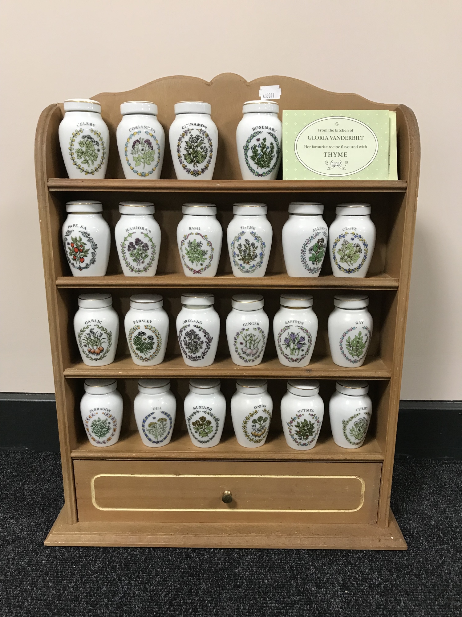 A spice rack containing twenty two china Gloria Vanderbilt spice jars