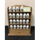 A spice rack containing twenty two china Gloria Vanderbilt spice jars