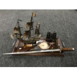 An inlaid mahogany twin handled serving tray, leather bound field glasses, vintage wooden galleon,