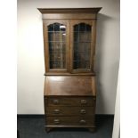 An Edwardian oak bureau bookcase