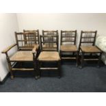 A set of six early twentieth century oak rush seated country chairs.