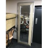 A silvered framed cushion hall mirror