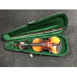 A violin and bow in soft case and a violin music book