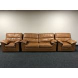 A late 20th century three piece tan leather lounge suite