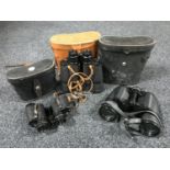 Three pairs of binoculars in leather cases,