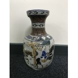 A 20th century Oriental pottery vase depicting warriors on horseback