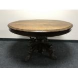 A late 19th century French oak dining table on a heavily carved oak pedestal