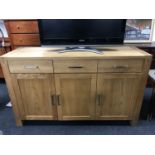 A contemporary pine triple door sideboard