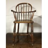 A 19th century elm child's Windsor chair, height 80 cm.
