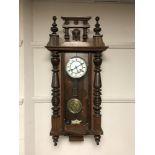 An Edwardian mahogany wall clock with enamelled dial