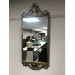 An ornate gilt framed hall mirror