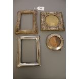 Four antique silver photograph frames.