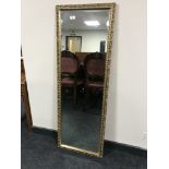 A gilt framed rectangular mirror with bevelled glass, 44.5 cm x 126.5 cm.