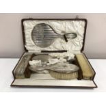 An early twentieth century six piece silver backed dressing table brush set, cased.