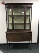 A Victorian mahogany display cabinet fitted cupboards beneath