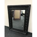 A Victorian style black framed mirror