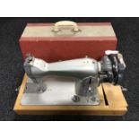 A cased hand sewing machine