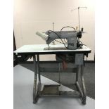 A Singer industrial treadle sewing machine in table