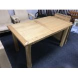 A contemporary oak dining table